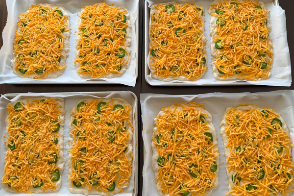 Jalapeno Cheese Bread: pizza dough, shredded cheddar cheese, fresh jalapeno pepper, olive oil.